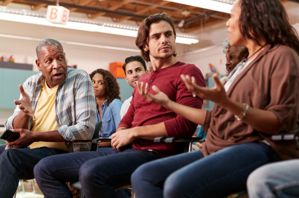 Multicultural group of homeowners meets to discuss issues in their community.