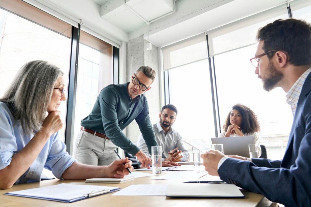Company board executives sitting around a table discuss data breach liability.
