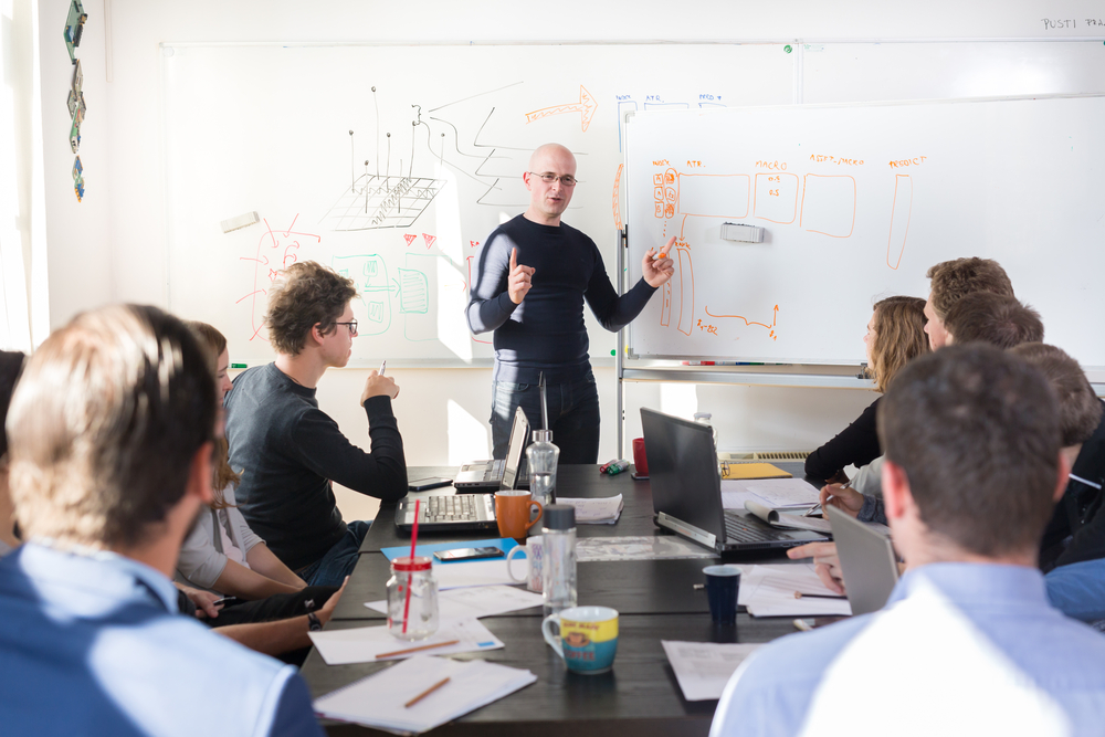 IT manager conducts cyber awareness training with company staff. 